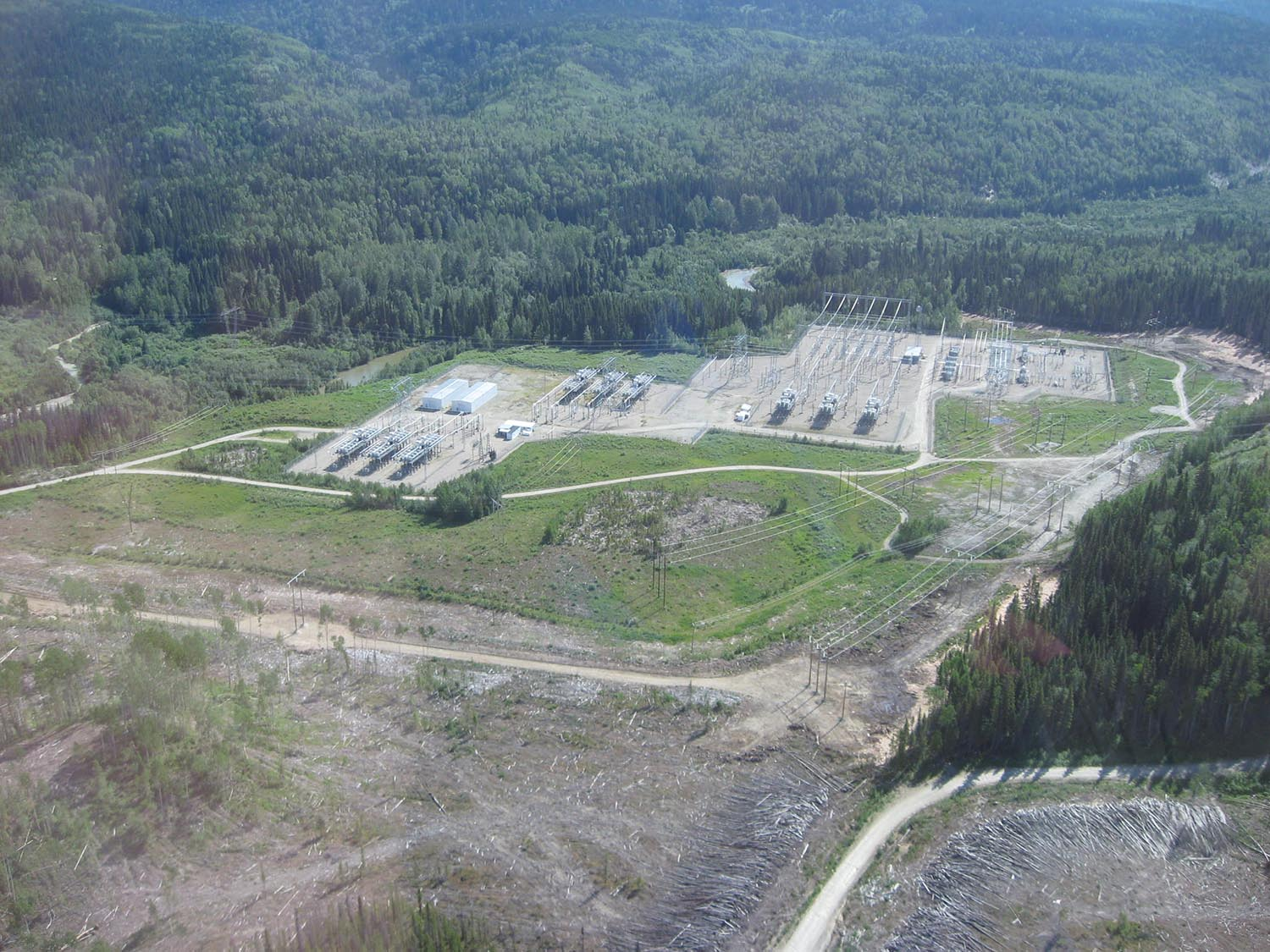 Aerial view of the Kennedy Substation south of Mackenzie, BC, surrounded by forest.