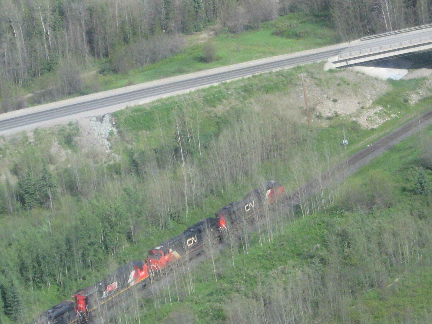CN Rail freight train passing beside Highway 97 in northern British Columbia.