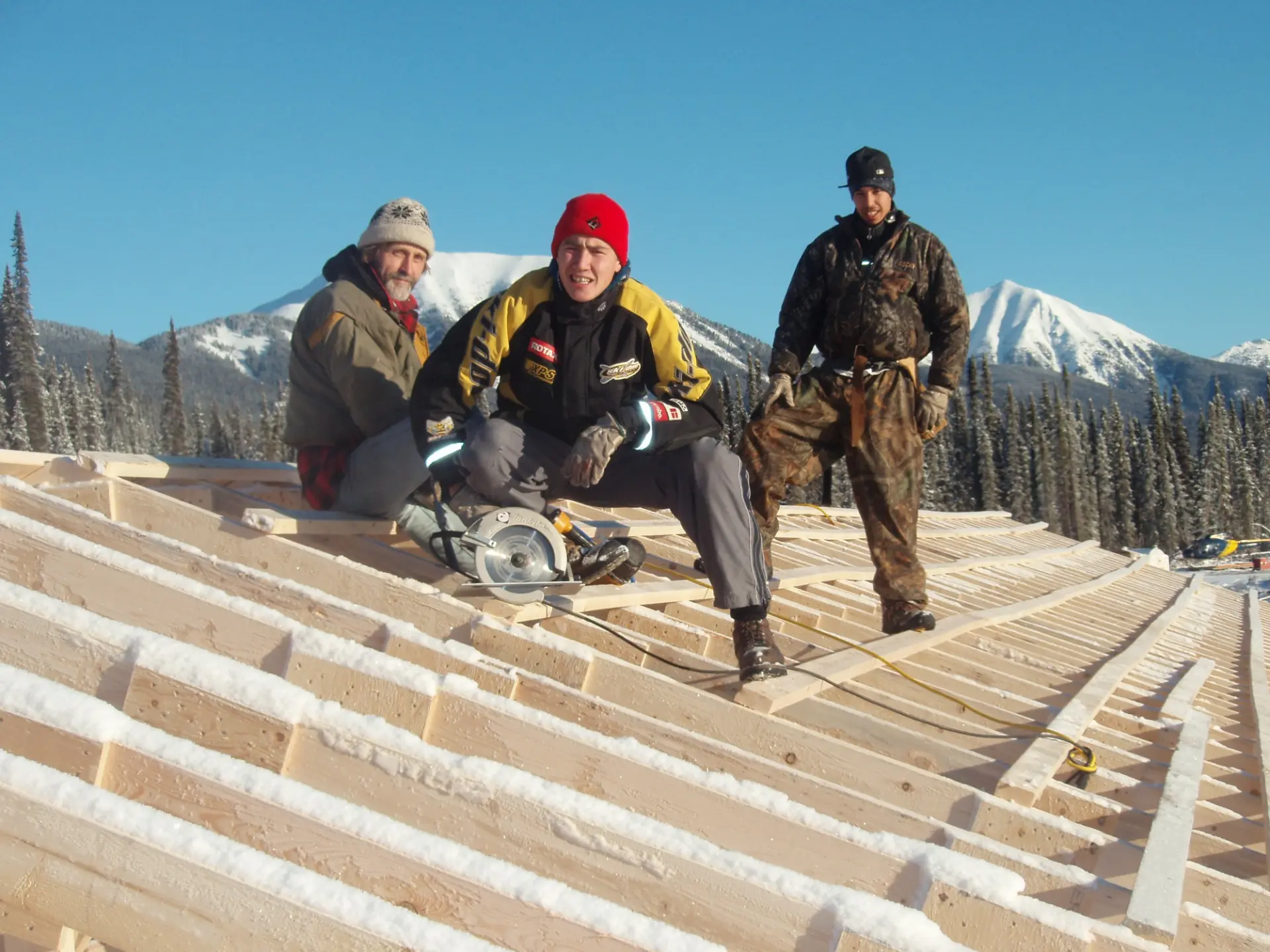 Construction crew from Kwadacha building snow rooves over camp bunkhouse in 2007