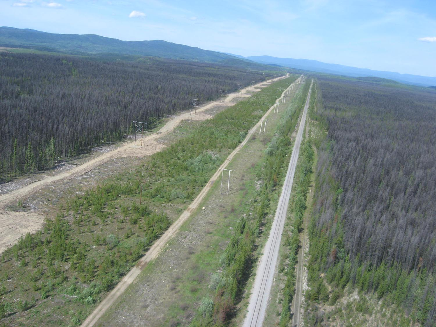 Aerial view of the powerline corridor running alongside the railway through northern British Columbia toward the Kemess mine site.